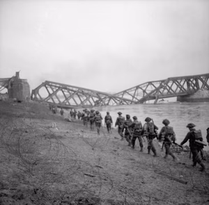 The British Army in North-west Europe 1944-45- Assault on the Rhine and Capture of Wesel This is one of a collection of pictures that show the landing from Buffaloes of the 1st Battalion Cheshire Regiment, who landed on the afternoon of 24th March 1945, in support of No.1 S.S Commando Brigade at Wesel. The bridge seen in background is the smashed railway bridge at Wesel.