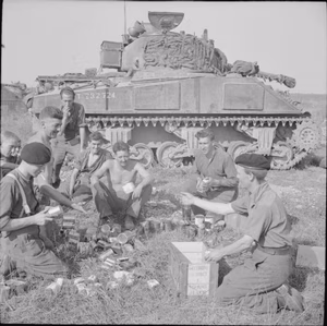 The British Army in the Normandy Campaign 1944 The crew of a Sherman tank of 1st Northamptonshire Yeomanry receive rations before the start of Operation 'Totalise', 7 August 1944.