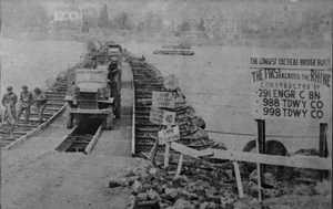 M-2 steel treadway bridge spanning the 1032 ft breadth of the Rhine was built in 32 hours under heavy enemy fire by the 291st Engineer Combat Battalion supported by the 988 and 998 Treadway Bridge Companies.