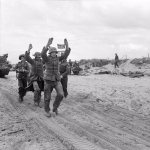 D-day - British Forces during the Invasion of Normandy 6 June 1944 German POWs being escorted along one of the Gold area beaches, 6 June 1944.
