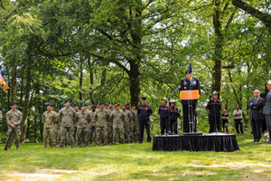 Maj. Gen. Jeffery Broadwater, the V Corps deputy commanding general, delivers featured remarks June 3 in Mortain, France, during a ceremony commemorating the Battle of Mortain held on “Hill 314” – the site of a remarkable defensive stand by 30th Infantry Division Soldiers 79 years ago. For five days, the DCG told an engaged local national crowd, around 700 surrounded Americans fought off assaults by the 17th Panzer Division, despite running dangerously low on ammunition and almost entirely lacking food and supplies. Despite losing 400 men during fierce fighting, the “GIs” held their crucial position until relief arrived, inflicting heavy casualties on the enemy during the process. Their courageous stand helped ensure the continued success of the U.S. breakout from Normandy in June 1944. The DCG joined town and regional officials, the USAF-E Band, support Soldiers, organizers and citizens of the small, picturesque Norman town for a captivating ceremony. Grateful local officials presented the DCG the town medal after the event. (Photo by Sgt. 1st Class Lisa Litchfield, USACAPOC)