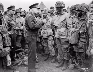 General Dwight D. Eisenhower addresses American paratroopers prior to D-Day. "Gen. Dwight D. Eisenhower gives the order of the Day. 'Full victory-nothing less' to paratroopers in England, just before they board their airplanes to participate in the first assault in the invasion of the continent of Europe." Eisenhower is meeting with US Co. E, 502nd Parachute Infantry Regiment (Strike) of the 101st Airborne Division, photo taken at Greenham Common Airfield in England about 8:30 p.m. on June 5, 1944. The General was talking about fly fishing with his men as he always did before a stressful operation (Eisenhower speaks with Hartsock). Memoir by Lt Wallace C. Strobel about this photo (seen wearing the number 23 around his neck): https://web.archive.org/web/20201123025151/http://www.historyaddict.com/Ike502nd.html