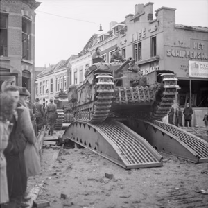 Churchill tanks of 34th Tank Brigade cross a temporary bridge in Roosendaal , Netherlands.