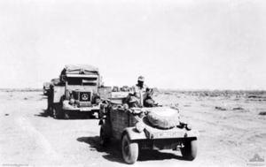 A convoy of Afrika Korps vehicles moving throught the desert. The vehicles normally travelled at intervals of approximately one hundred metres in case of an air attack, which, in the case of this photograph, was apparently unlikely. The convoy is lead by a VW Kübelwagen.