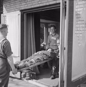 Arnhem 17 - 25 September 1944: A wounded paratrooper of 1st Airborne Division being taken into the front line dressing station, Arnhem.