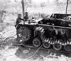 U.S. Army Brig. Gen. Frank A. Allen, left, points out the distinctive features of the German Panzer IV tank to Maj. Gen. Ernest Harmon, Fifth Army, Grosseto area, Italy. 22 June 1944.