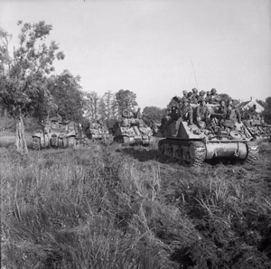 The British Army in Normandy 1944 Sherman tanks carrying infantry wait to advance at the start of Operation 'Goodwood', 18 July 1944.