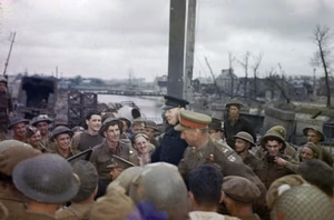 The Visit of the Prime Minister, Winston Churchill To Caen, Normandy, 22 July 1944 The Prime Minister, the Rt Hon Winston Churchill, MP, standing in a staff car, talking to British and Canadian troops at the 'Winston' bridge over the River Orne. With the Prime Minister is the Commander of the British 2nd Army, Lieutenant General Sir Miles Dempsey.