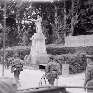 D-day - British Forces during the Invasion of Normandy 6 June 1944 British 3rd Division troops passing a First World War memorial in Hermanville-sur-Mer, 6 June 1944.