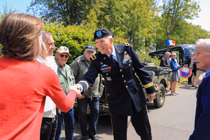 Maj. Gen. Jeffery Broadwater, the V Corps deputy commanding general, greets well-wishers June 3 in Mortain, France before delivering featured remarks during a ceremony commemorating the Battle of Mortain held on “Hill 314” – the site of a remarkable defensive stand by 30th Infantry Division Soldiers 79 years ago. For five days, the DCG told an engaged local national crowd, around 700 surrounded Americans fought off assaults by the 17th Panzer Division, despite running dangerously low on ammunition and almost entirely lacking food and supplies. Despite losing 400 men during fierce fighting, the “GIs” held their crucial position until relief arrived, inflicting heavy casualties on the enemy during the process. Their courageous stand helped ensure the continued success of the U.S. breakout from Normandy in June 1944. The DCG joined town and regional officials, the USAF-E Band, support Soldiers, organizers and citizens of the small, picturesque Norman town for a captivating ceremony. Grateful local officials presented the DCG the town medal after the event. (Photo by Sgt. 1st Class Lisa Litchfield, USACAPOC)