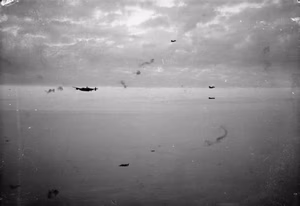 Royal Air Force Bomber Command, 1942-1945. Avro Lancasters and Handley Page Halifaxes fly through anti-aircraft fire to bomb fortified villages east of Caen, France in a dawn attack by 942 aircraft, before the commencement of the Second Army's armoured attack in the Normandy battle area (Operation GOODWOOD).