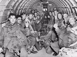 British Paratroops of 1st (British) Airborne Division give the 'V'-sign and "thumbs up" inside one of the C-47 transport aircraft.