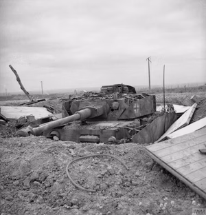 A knocked-out German PzKpfw IV tank in a hull-down position, 13 July 1944. Additional info: "A dug-in Panzer IV of the 1/22nd Panzer Regiment, photographed near Lebisey after being knocked out during Operation Charnwood.(Battle for Caen, p. 34, by Simon Trew. ISBN:0-7509-3010-1)