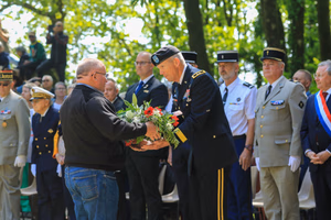 Maj. Gen. Jeffery Broadwater, the V Corps deputy commanding general, prepares to lay a wreath during a ceremony commemorating the Battle of Mortain held on “Hill 314” – the site of a remarkable defensive stand by 30th Infantry Division Soldiers 79 years ago. For five days, the DCG told an engaged local national crowd, around 700 surrounded Americans fought off assaults by the 17th Panzer Division, despite running dangerously low on ammunition and almost entirely lacking food and supplies. Despite losing 400 men during fierce fighting, the “GIs” held their crucial position until relief arrived, inflicting heavy casualties on the enemy during the process. Their courageous stand helped ensure the continued success of the U.S. breakout from Normandy in June 1944. The DCG joined town and regional officials, the USAF-E Band, support Soldiers, organizers and citizens of the small, picturesque Norman town for a captivating ceremony. Grateful local officials presented the DCG the town medal after the event. (Photo by Sgt. 1st Class Lisa Litchfield, USACAPOC)