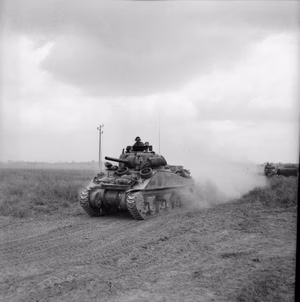 The British Army in Normandy 1944 A Sherman tank advances during operations in the Odon valley, west of Caen, 16 July 1944.
