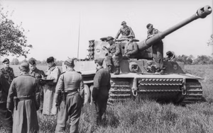 Nordfrankreich.- Soldaten vor Panzer VI "Tiger I" des SS-Pz-Korps "Leibstandarte Adolf Hitler"; PK 698 — Nordfrankreich — Information from http://www.panzer.punkt.pl: Battalion commander Heinz von Westernhagen and tank commanders of the Leibstandarte 3rd company confer near one of their vehicles. These pictures were taken during a field exercise east of Amiens, France in May 1944.