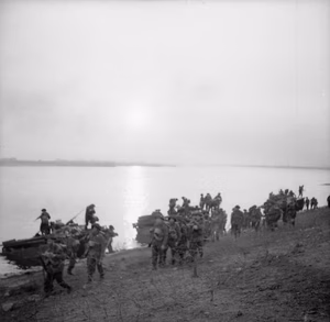 The British Army in North-west Europe 1944-45- Assault on the Rhine and Capture of Wesel This is one of a collection of pictures that show the landing from Buffaloes of the 1st Battalion Cheshire Regiment, who landed on the afternoon of 24th March 1945, in support of No.1 S.S Commando Brigade at Wesel. The bridge seen in background is the smashed railway bridge at Wesel.