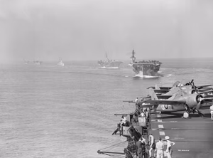 A view from HMS PURSUER of other assault carriers in the naval task force which took part in the landings in the south of France, 7 August 1944. Scene from HMS PURSUER of other assault carriers in the force which took part in the landings in the south of France on the 15 August 1944. Leading are HMS ATTACKER and HMS KHEDIVE. Three Grumman Wildcats can be seen parked on the edge of PURSUER's flight deck.