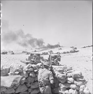 The British Army in North Africa 1941 A Bren gunner in action against enemy bombers attacking Tobruk. In the distance a derelict Italian lorry, loaded with ammunition, has been hit, 12 September 1941.