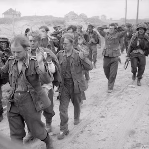 D-day - British Forces during the Invasion of Normandy 6 June 1944 German prisoners being marched along Queen beach, Sword area, 6 June 1944.