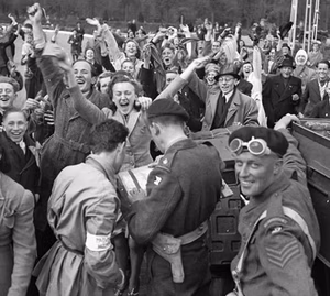 Dutch civilians and Canadian Army troops celebrating the Liberation of the Netherlands.