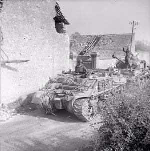 The British Army in Normandy 1944 A Sherman ARV towing a German PzKpfw IV tank captured near Cagny, 19 July 1944.
