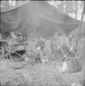 The British Army in North-west Europe 1944-45 The crew of a machine gun carrier of the Middlesex Regiment shelter beneath a tarpaulin erected over their vehicle in the Reichswald, 12 February 1945.