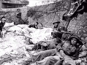 Wounded Canadian soldiers await evacuation from a casualty clearing station on Juno beach, June 6, 1944.