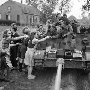 A carrier crew of 8th Rifle Brigade hands out chocolate to Dutch civilians during the advance of 11th Armoured Division in Holland, 22 September 1944. A carrier crew of 8th Rifle Brigade hands out chocolate to Dutch civilians during the advance of 11th Armoured Division in Holland, 22 September 1944.