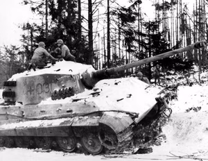 An abanoned German Tiger II tank on the road between Bastogne and Houffalize, Belgium, in January 1945.