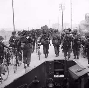British troops from 3rd Division, some with bicycles, move inland from Sword Beach, Normandy, 6 June 1944. Troops from 3rd Division, some with bicycles, move inland from Sword Beach, 6 June 1944. Photograph taken from a Universal carrier.