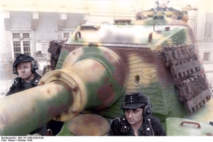 This is a retouched picture , which means that it has been digitally altered from its original version. Modifications: recolored . The original can be viewed here: Bundesarchiv Bild 101I-680-8282A-09, Budapest, Panzersoldaten in Panzer VI (Tiger II).jpg : . Modifications made by Ruffneck'88 . .mw-parser-output table.commons-file-information-table,.mw-parser-output .fileinfotpl-type-information,.mw-parser-output .fileinfotpl-type-artwork{border:1px solid var(--border-color-base,#a2a9b1);background-color:var(--background-color-interactive-subtle,#f8f9fa);padding:5px;font-size:95%;border-spacing:2px;box-sizing:border-box;margin:0;width:100%;color:inherit}.mw-parser-output table.commons-file-information-table>tbody>tr,.mw-parser-output .fileinfotpl-type-information>tbody>tr,.mw-parser-output .fileinfotpl-type-artwork>tbody>tr{vertical-align:top}.mw-parser-output table.commons-file-information-table>tbody>tr>td,.mw-parser-output table.commons-file-information-table>tbody>tr>th,.mw-parser-output .fileinfotpl-type-information>tbody>tr>td,.mw-parser-output .fileinfotpl-type-information>tbody>tr>th,.mw-parser-output .fileinfotpl-type-artwork>tbody>tr>td,.mw-parser-output .fileinfotpl-type-artwork>tbody>tr>th{padding:4px}.mw-parser-output .fileinfo-paramfield{background:#ccf;text-align:right;padding-right:0.4em;width:15%;font-weight:bold;color:inherit}.mw-parser-output .commons-file-information-table+table.commons-file-information-table,.mw-parser-output .commons-file-information-table+div.commons-file-information-table>table{border-top:0;padding-top:0;margin-top:-8px}@media only screen and (max-width:719px){.mw-parser-output table.commons-file-information-table,.mw-parser-output .commons-file-information-table .fileinfotpl-type-information,.mw-parser-output .commons-file-information-table .fileinfotpl-type-artwork{border-spacing:0;padding:0;word-break:break-word;width:100%!important}.mw-parser-output .commons-file-information-table>tbody,.mw-parser-output .fileinfotpl-type-information>tbody,.mw-parser-output .fileinfotpl-type-artwork>tbody{display:block}.mw-parser-output .commons-file-information-table>tbody>tr>td,.mw-parser-output .commons-file-information-table>tbody>tr>th,.mw-parser-output .fileinfotpl-type-information>tbody>tr>td,.mw-parser-output .fileinfotpl-type-information>tbody>tr>th,.mw-parser-output .fileinfotpl-type-artwork>tbody>tr>td,.mw-parser-output .fileinfotpl-type-artwork>tbody>tr>th{padding:0.2em 0.4em;text-align:left;text-align:start}.mw-parser-output .commons-file-information-table>tbody>tr,.mw-parser-output .fileinfotpl-type-information>tbody>tr,.mw-parser-output .fileinfotpl-type-artwork>tbody>tr{display:flex;flex-direction:column}.mw-parser-output .commons-file-information-table+table.commons-file-information-table,.mw-parser-output .commons-file-information-table+div.commons-file-information-table>table{margin-top:-1px}.mw-parser-output table .fileinfo-paramfield{box-sizing:border-box;flex:1 0 100%;width:100%}}.mw-parser-output table.commons-file-information-table,.mw-parser-output .fileinfotpl-type-information,.mw-parser-output .fileinfotpl-type-artwork,.mw-parser-output .fileinfo-paramfield{color:var(--color-base,#202122)}html.skin-theme-clientpref-night .mw-parser-output .fileinfo-paramfield{background:#2a2a5c;color:white}html.skin-theme-clientpref-night .mw-parser-output .fileinfotpl-type-artwork tbody>tr>th[style*="#ccf"]{background-color:#2a2a5c!important;color:white}@media screen and (prefers-color-scheme:dark){html.skin-theme-clientpref-os .mw-parser-output .fileinfo-paramfield{background:#2a2a5c;color:white}html.skin-theme-clientpref-os .mw-parser-output .fileinfotpl-type-artwork tbody>tr>th[style*="#ccf"]{background-color:#2a2a5c!important;color:white}} Budapest, Panzersoldaten in Panzer VI (Tiger II) ( ) Photographer Faupel Archive description InfoField Description provided by the archive when the original description is incomplete or wrong. You can help by reporting errors and typos at Commons:Bundesarchiv/Error reports . Ungarn, Budapest.- "Unternehmen Panzerfaust". Panzersoldaten in einem Panzer VI "Tiger II" (Königstiger); PK Eins Kp Lw zbV Title Budapest, Panzersoldaten in Panzer VI (Tiger II) Description Information added by Wikimedia users. Schwere Panzer-Abteilung 503. Only Tiger II unit to go to Budapest [ 1 ] Depicted place Budapest Date October 1944 date QS:P571,+1944-10-00T00:00:00Z/10 Collection German Federal Archives Native name Das Bundesarchiv Parent institution Federal Government Commissioner for Culture and Media Location Koblenz (headquarters) Coordinates 50° 20′ 32.71″ N, 7° 34′ 21.22″ E Established 1946 Website www.bundesarchiv.de Authority file : Q685753 VIAF : 137346469 ISNI : 0000000405552728 LCCN : n92025526 NLA : 36455393 OSM : 1844909 WorldCat institution QS:P195,Q685753 Current location Propagandakompanien der Wehrmacht - Heer und Luftwaffe (Bild 101 I) Accession number Bild 101I-680-8282A-09 Source This image was provided to Wikimedia Commons by the German Federal Archive (Deutsches Bundesarchiv) as part of a cooperation project . The German Federal Archive guarantees an authentic representation only using the originals (negative and/or positive), resp. the digitalization of the originals as provided by the Digital Image Archive .