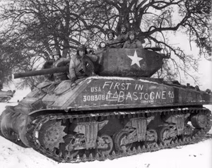 The 'Cobra King' crew -- 1st Lt. Charles Boggess, Cpl. Milton Dickerman and Pvts. James G. Murphy, Hubert S. Smith and Harold Hafner -- pose for a celebratory photo in the vicinity of Bastogne, Belgium shortly after the tankers led the armor and infantry column that liberated the city in December 1944.