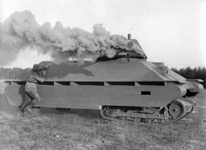 For documentary purposes the German Federal Archive often retained the original image captions , which may be erroneous, biased, obsolete or politically extreme . Übung, Panzer-Nahbekämpfung Scherl Bilderdienst Ausbildung bei der Panzergrenadier-Division "Großdeutschland", die sich überwiegend aus Freiwilligen aus allen Gauen des Reiches zusammensetzt und die im Verlaufe dieses Krieges unsterblichen Ruhm an ihre Fahnen geheftet hat. Besonders sorgfältig und vielseitig ist die Ausbildung des Ersatzes für diese Kerntruppe, die bei der Ersatzbrigade "Großdeutschland", dem Heimattruppenteil der ruhmreichen Division, erfolgt. UBz.: Panzer-Nahbekämpfung am fahrenden Modell. Ganz systematisch folgt der Ausbildung am stehenden Modell das Üben am fahrenden. Die Sprengladung wird am durch Nebelhandgranaten geblendeten Panzer-Modell angebracht Foto: Schwahn 5.11.43 5558-43 5558-43 [Deutschland, Ausbildung bei der Ersatzbrigade der Panzergrenadier-Division "Großdeutschland", Panzerbekämpfung]