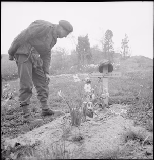 The British Army in North-west Europe 1944-45 A soldier examines the grave of a 1st Airborne Division soldier killed at Arnhem the previous September, 15 April 1945.