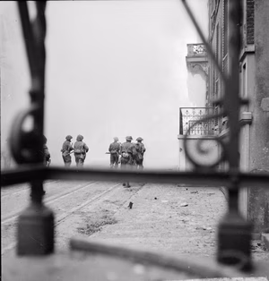 The British Army in North-west Europe 1944-45 Troops of the 2nd Essex Regiment patrol the streets in Arnhem, 14 April 1945.