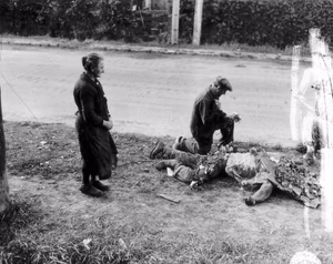 French people place flowers on the bodies of American soldiers.