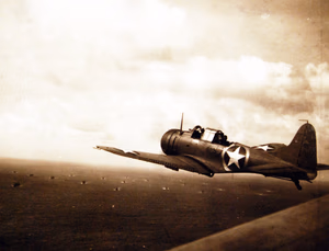 80-G-30218: Operation Torch, November 1942. SBD Dauntless planes from USS Ranger (CV-4) en route to invade French North Africa. A Navy scout bomber flies on anti-submarine patrol. Official U.S. Navy Photograph, now in the collections of the National Archives. (2017/06/06).