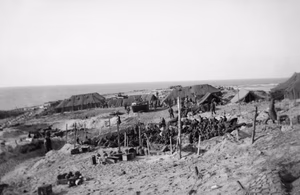 Invasion of Walcheren Island [westkapelle] The occupation of Walcheren Island is going fast. Flushing is in the hands of the British and troops fanning out to the West are close to the Marine Commandos coming down from the Westkapelle beachhead (where these pictures were taken). This image shows German prisoners on Walcheren, in a Prisoner of War cage.