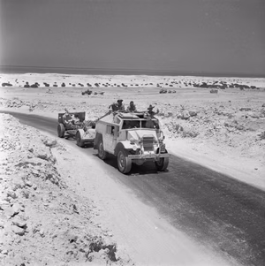 The British Army in North Africa 1942 A Quad artillery tractor and 25-pdr field gun of 9th Australian Division, 9 July 1942.