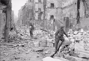 The British Army in Normandy 1944 A British soldier carries a little girl through the devastation of Caen, 10 July 1944.