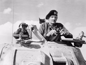 Lieutenant General Bernard Montgomery, commanding the British Eighth Army in North Africa, in the turret of his Grant command tank at El Alamein, 5 November 1942. Lieutenant General B L Montgomery, General Officer Commanding Eighth Army, watches the beginning of the German retreat from El Alamein from the turret of his Grant Tank. He is wearing his famous tank beret.
