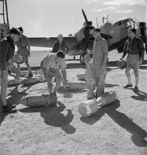 Royal Air Force- Operations in the Middle East and North Africa, 1940-1943. Armourers fitting tail fins to 250-lb GP bombs prior to loading them on board a Martin Baltimore of No. 232 Wing RAF at LG 86, Egypt, during Operation LIGHTFOOT, the first phase of the Alamein offensive.