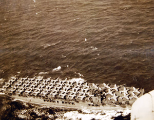 80-G-30221: Operation Torch, November 1942. USS Chenango (ACV-28) with Army pursuit planes, P-40’s, on the flight deck during the amphibious force invasion of French North Africa. Official U.S. Navy Photograph, now in the collections of the National Archives. (2017/06/06).
