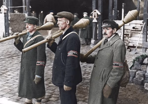 This is a retouched picture , which means that it has been digitally altered from its original version. Modifications: recolored . The original can be viewed here: Bundesarchiv Bild 183-J31320, Berlin, Posten beim Bau einer Straßensperre.jpg : . Modifications made by Ruffneck88 . .mw-parser-output table.commons-file-information-table,.mw-parser-output .fileinfotpl-type-information,.mw-parser-output .fileinfotpl-type-artwork{border:1px solid var(--border-color-base,#a2a9b1);background-color:var(--background-color-interactive-subtle,#f8f9fa);padding:5px;font-size:95%;border-spacing:2px;box-sizing:border-box;margin:0;width:100%;color:inherit}.mw-parser-output table.commons-file-information-table>tbody>tr,.mw-parser-output .fileinfotpl-type-information>tbody>tr,.mw-parser-output .fileinfotpl-type-artwork>tbody>tr{vertical-align:top}.mw-parser-output table.commons-file-information-table>tbody>tr>td,.mw-parser-output table.commons-file-information-table>tbody>tr>th,.mw-parser-output .fileinfotpl-type-information>tbody>tr>td,.mw-parser-output .fileinfotpl-type-information>tbody>tr>th,.mw-parser-output .fileinfotpl-type-artwork>tbody>tr>td,.mw-parser-output .fileinfotpl-type-artwork>tbody>tr>th{padding:4px}.mw-parser-output .fileinfo-paramfield{background:#ccf;text-align:right;padding-right:0.4em;width:15%;font-weight:bold;color:inherit}.mw-parser-output .commons-file-information-table+table.commons-file-information-table,.mw-parser-output .commons-file-information-table+div.commons-file-information-table>table{border-top:0;padding-top:0;margin-top:-8px}@media only screen and (max-width:719px){.mw-parser-output table.commons-file-information-table,.mw-parser-output .commons-file-information-table .fileinfotpl-type-information,.mw-parser-output .commons-file-information-table .fileinfotpl-type-artwork{border-spacing:0;padding:0;word-break:break-word;width:100%!important}.mw-parser-output .commons-file-information-table>tbody,.mw-parser-output .fileinfotpl-type-information>tbody,.mw-parser-output .fileinfotpl-type-artwork>tbody{display:block}.mw-parser-output .commons-file-information-table>tbody>tr>td,.mw-parser-output .commons-file-information-table>tbody>tr>th,.mw-parser-output .fileinfotpl-type-information>tbody>tr>td,.mw-parser-output .fileinfotpl-type-information>tbody>tr>th,.mw-parser-output .fileinfotpl-type-artwork>tbody>tr>td,.mw-parser-output .fileinfotpl-type-artwork>tbody>tr>th{padding:0.2em 0.4em;text-align:left;text-align:start}.mw-parser-output .commons-file-information-table>tbody>tr,.mw-parser-output .fileinfotpl-type-information>tbody>tr,.mw-parser-output .fileinfotpl-type-artwork>tbody>tr{display:flex;flex-direction:column}.mw-parser-output .commons-file-information-table+table.commons-file-information-table,.mw-parser-output .commons-file-information-table+div.commons-file-information-table>table{margin-top:-1px}.mw-parser-output table .fileinfo-paramfield{box-sizing:border-box;flex:1 0 100%;width:100%}}.mw-parser-output table.commons-file-information-table,.mw-parser-output .fileinfotpl-type-information,.mw-parser-output .fileinfotpl-type-artwork,.mw-parser-output .fileinfo-paramfield{color:var(--color-base,#202122)}html.skin-theme-clientpref-night .mw-parser-output .fileinfo-paramfield{background:#2a2a5c;color:white}html.skin-theme-clientpref-night .mw-parser-output .fileinfotpl-type-artwork tbody>tr>th[style*="#ccf"]{background-color:#2a2a5c!important;color:white}@media screen and (prefers-color-scheme:dark){html.skin-theme-clientpref-os .mw-parser-output .fileinfo-paramfield{background:#2a2a5c;color:white}html.skin-theme-clientpref-os .mw-parser-output .fileinfotpl-type-artwork tbody>tr>th[style*="#ccf"]{background-color:#2a2a5c!important;color:white}} Photographer Unknown Unknown Original caption For documentary purposes the German Federal Archive often retained the original image captions , which may be erroneous, biased, obsolete or politically extreme . Berlin, Posten beim Bau einer Straßensperre ADN-ZB/Archiv Das faschistische Deutschland im II. Weltkrieg 1939-45 Berlin wird am 1. Februar 1945 zum "Verteidigungsbereich" erklärt. Es werden Barrikaden errichtet, Stellungen und Panzergräben ausgehoben. Drei Volkssturmsoldaten mit Panzerfäusten stehen am 10. März auf Posten beim Bau einer Straßensperre an einer Bahnunterführung. 343-45 [Scherl Bilderdienst] Depicted place Berlin Date 10 March 1945 date QS:P571,+1945-03-10T00:00:00Z/11 Collection German Federal Archives Native name Das Bundesarchiv Parent institution Federal Government Commissioner for Culture and Media Location Koblenz (headquarters) Coordinates 50° 20′ 32.71″ N, 7° 34′ 21.22″ E Established 1946 Website www.bundesarchiv.de Authority file : Q685753 VIAF : 137346469 ISNI : 0000000405552728 LCCN : n92025526 NLA : 36455393 OSM : 1844909 WorldCat institution QS:P195,Q685753 Current location Allgemeiner Deutscher Nachrichtendienst - Zentralbild (Bild 183) Accession number Bild 183-J31320 Source This image was provided to Wikimedia Commons by the German Federal Archive (Deutsches Bundesarchiv) as part of a cooperation project . The German Federal Archive guarantees an authentic representation only using the originals (negative and/or positive), resp. the digitalization of the originals as provided by the Digital Image Archive .