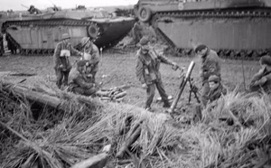 Invasion of Walcheren Island [westkapelle] The occupation of Walcheren Island is going fast. Flushing is in the hands of the British and troops fanning out to the West are close to the Marine Commandos coming down from the Westkapelle beachhead (where these pictures were taken). This image shows 3" mortars in action from behind the cover of amphibious tanks.