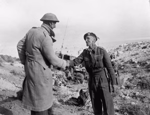 Join up of the 8th Army and the Tobruk garrison in Libya. Lieutenant Colonel Hartnell, left, greets a British tank officer, 27 November 1941