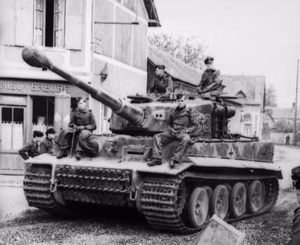 Nordfrankreich.- Panzer VI "Tiger I" (Turmnummer 133) des 1. SS-Pz.-Korps "Leibstandarte Adolf Hitler" in Ortschaft vor Geschäft "Nieuverburg", im Vordergrund Schwimmkübel; PK 698 — Frankreich