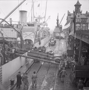 The British Army in North-west Europe 1944-45 Oil being unloaded from the SS 'Fort Cataraqui' in the port of Antwerp, 30 November 1944. This was the first ship to berth at the port following the opening of the Scheldt Estuary.