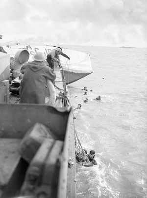 British Marine Commandos Land on Walcheren at Westkapelle. 1 November 1944, on Board An Lci (s). the Final Phase of the Battle To Free the Approaches To the Belgian Port of Antwerp Began When Royal Marine Commandos Landed at Dawn at Westkapelle, the Western Most Point of the Island of Walcheren. LCG survivors being picked up by an LCI(S) acting as a hospital ship. Smoke of battle ashore is in the background